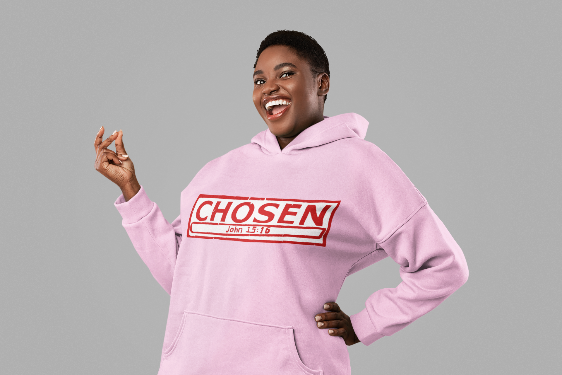 African American woman with pink hoodie with the words "Chosen John 15:16" in red like a stamp  on front