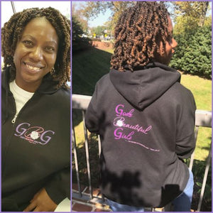 African American woman with braids wearing Black zippered hoodie with the letters GBG in purple and pink on the front. The words "God's Beautiful Girls" in purple and pink letters on the back.