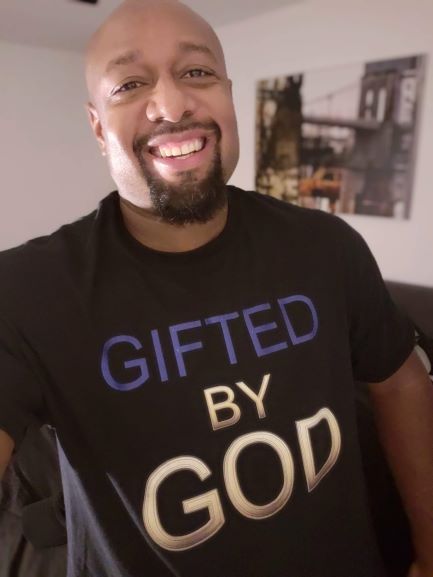 African American man in black shirt with Gifted By God on front