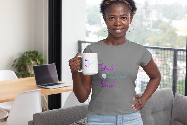 African American woman holding white coffee mug with the words "God's Beautiful Girls" on the mug in purple and turquoise letters. 