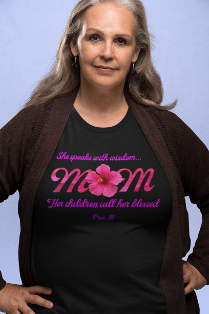 Mom wearing a black t-shirt that says "She is filled with wisdom"  in purple letters on top "MOM" with a pink hibiscus flower in the center. "Her children call her Blessed" to bottom. in purple letters.